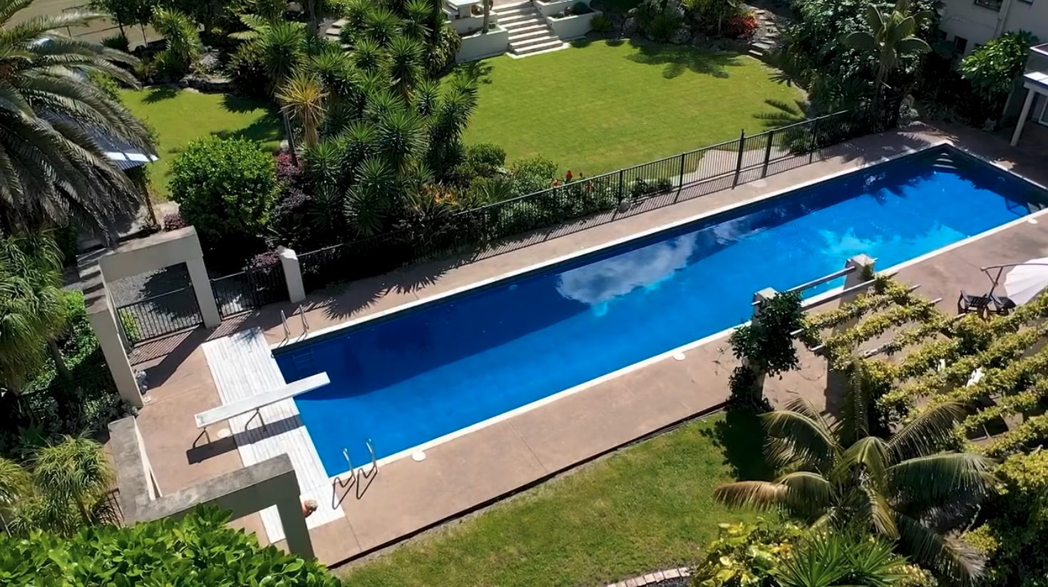 The estate from above — the lap pool, lawn and surrounding gardens